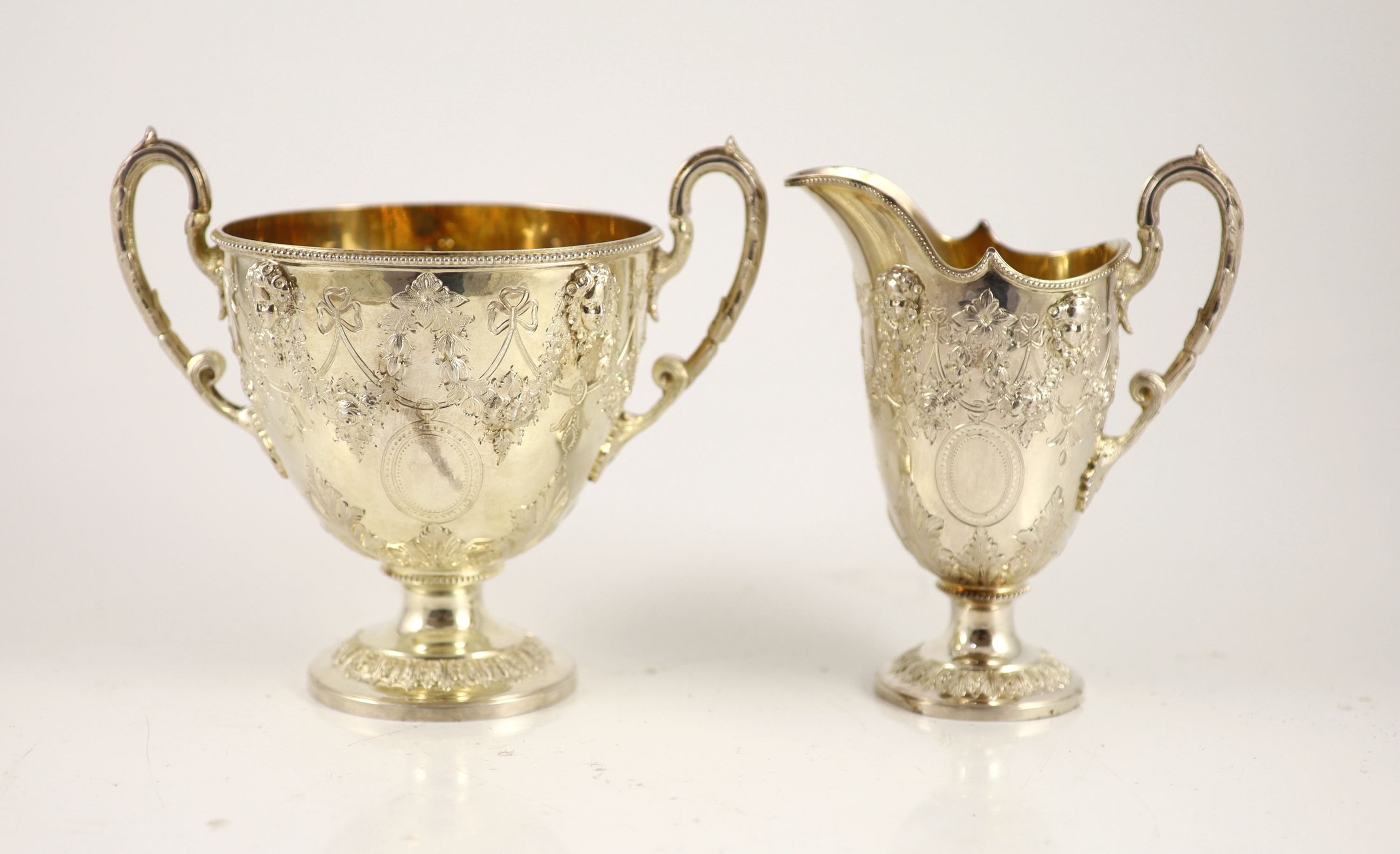 A Victorian embossed silver four-piece tea and coffee service of classical vase form, London 1886, Martin, Hall & Co (Richard Martin & Ebenezer Hall)